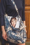 Hobo bag with animal patterns and adjustable strap.